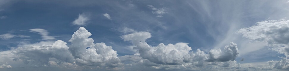 Russia. South of Western Siberia. Panorama of the daytime summer sky with cumulus clouds over the fields of Kuznetsk Alatau.