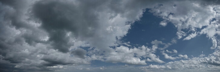 Russia. South of Western Siberia. Panorama of the daytime summer sky with cumulus clouds over the fields of Kuznetsk Alatau.