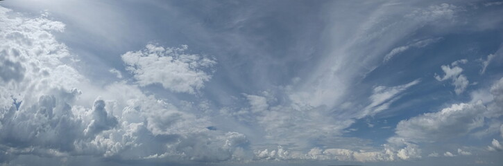 Russia. South of Western Siberia. Panorama of the daytime summer sky with cumulus clouds over the fields of Kuznetsk Alatau.