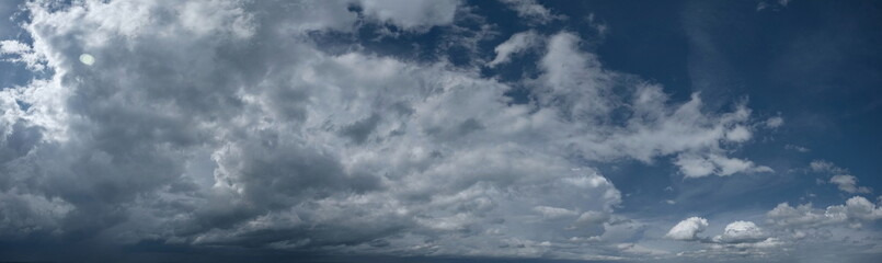 Russia. South of Western Siberia. Panorama of the daytime summer sky with cumulus clouds over the fields of Kuznetsk Alatau.