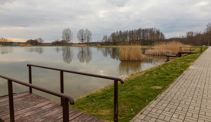 Naklejka premium Landscape in the countryside by the lake. A quiet place to relax by the water.
