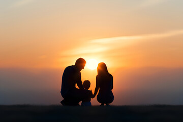A beautiful silhouette of a mother, father and her child at sunset,