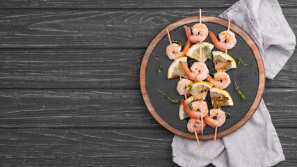 Shrimps in a plate of a wooden background