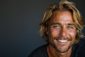 Obraz premium Portrait of a Smiling Man with Long Blond Hair