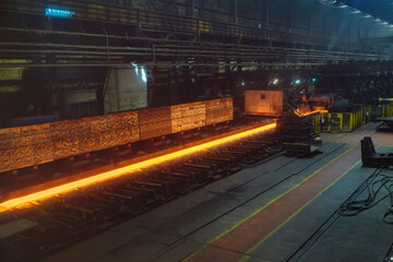 Rolled metal factory. Hot iron slab moving on conveyor of metal rolling mill © Mulderphoto