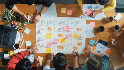 Top down aerial view of business team making scrum task board at meeting room. Group of people...