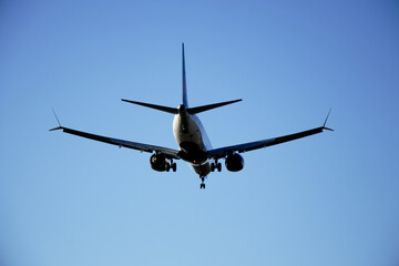 Commercial airplane landing - low angle back view
