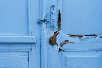 Old bright blue colored wooden doors - chipped paint - close up