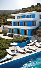 Greek beach hotel located at the water's edge, overlooking the calm sea. Holidays in a seaside resort,
