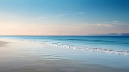 Obraz premium A serene sandy beach located at the water's edge, overlooking the calm sea.