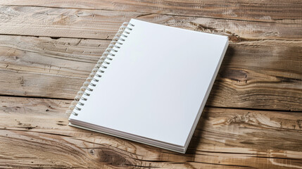 A spiral bound notebook sits on a wooden table