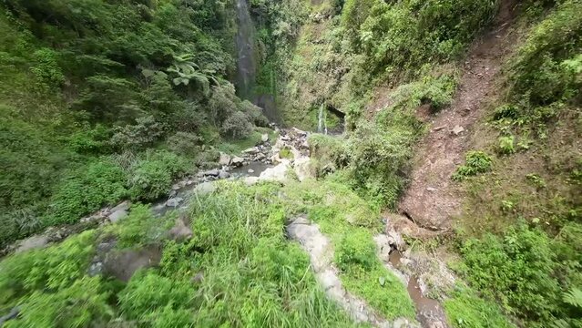 flying an fpv drone on a river and waterfall