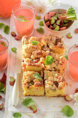 Fresh and tasty rhubarb yeast cake served with red juice.