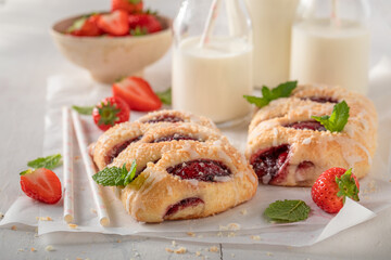 Homemade and sweet strawberry yeast cake with crumble and glaze.