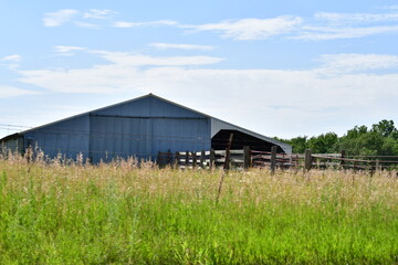 Obraz premium Metal Barn in a Farm Field