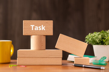 There is wood block with the word TASK. It is as an eye-catching image.