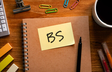 There is sticky note with the word BS. It is an abbreviation for Balance sheet as eye-catching...