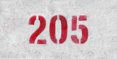 Red Number 205 on the white wall. Spray paint.