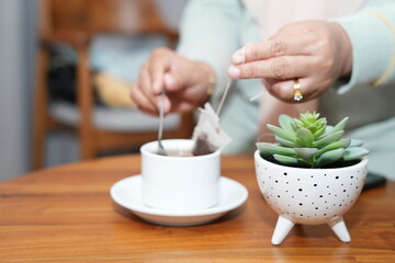 person holding a cup of tea