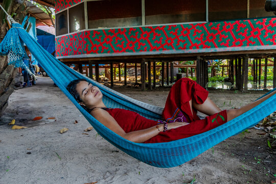 Girl in dress resting on an amaca