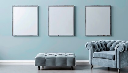 Three square frames on a pale blue wall in a living room. The room features a gray velvet armchair and a matching blue ottoman.