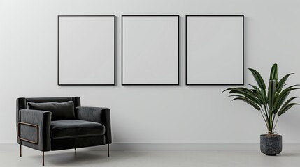 Three square frames on a white wall in a minimalist living room with a dark gray velvet armchair and a small potted plant.