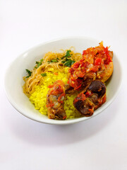 Indonesian Feast in a Cup: Nasi Kuning with Chicken, Egg, and Fragrant Rice on a White Background
