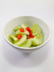Cucumber and Chili Slices in a White Cup on a Clean Background