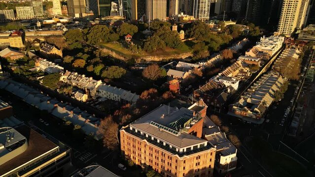 Sydney, Australia: Aerial drone footage of Sydney business district skyline and the Observatory Hill Park and historic building in Australia largest city. Shot with a tilt up motion at sunset