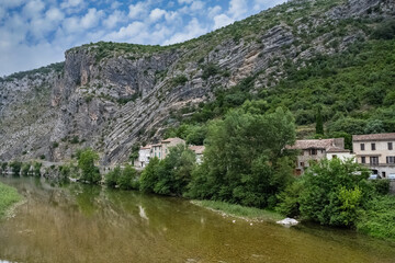 Fototapeta premium Anduze, French village, houses on the river, porte of the Cevennes 