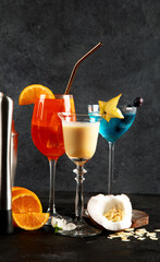 Summer cocktails in classic glasses on a black background. Party time. Tasty drinks