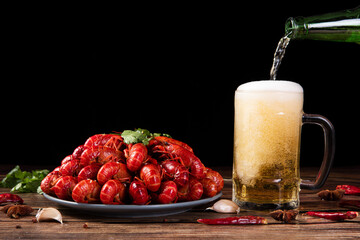 boiled Asian Food Spicy crawfish and beer on wooden table.