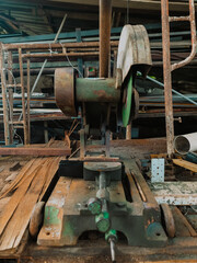 Close-up of vintage metal cutting machine in workshop.