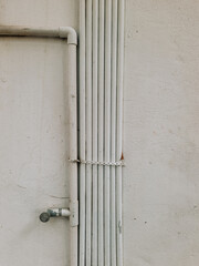 Pipeline Plumbing water system on white wall. Building facility.
