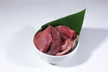 Porcelain bowl decorated with banana leaves, serving pieces of beef