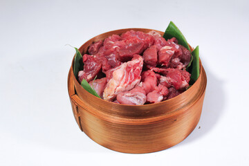 Bamboo baskets lined with banana leaves serve diced beef and goat