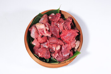 The beef is cut into cubes and served on a bamboo basket lined with banana leaves