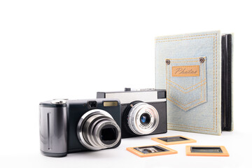 two retro 35mm film cameras and a photo album for photographs