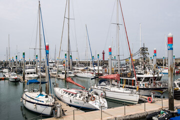 Big and small yachts anchored in the port
