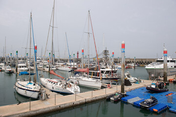 Big and small yachts anchored in the port
