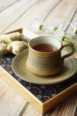 Ginger tea on wooden background.