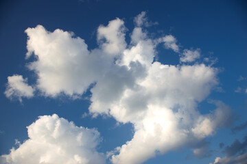 Obraz premium Nature, air and blue sky with clouds, sunshine and warm climate with meteorology on horizon. Heaven, dream and calm summer weather with environment, greenhouse effect and natural skyline in morning