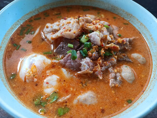 Thai spicy noodle soup with pork and fish ball in bowl