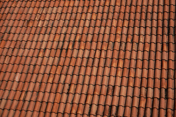 red roof texture. brown Clay tile roof. vintage style.  tiled ceramic roof as a retro styled background.