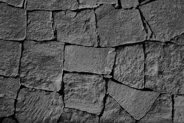 Texture wall of flat stone masonry. Wall cladding with coarse decorative rock stone. Not a seamless texture. abstract brick background, cinder block. old gray cinder block wall cement backdrop.