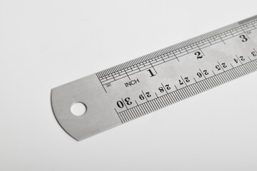 Iron ruler on a white background. Stainless steel ruler. Stationery and work tools made of metal...