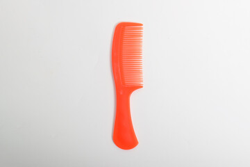 Red colored Plastic Hair Comb isolated on white background