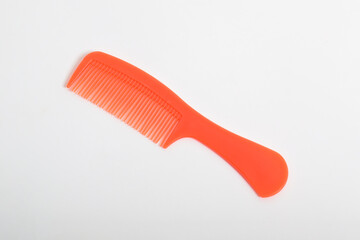 Red colored Plastic Hair Comb isolated on white background