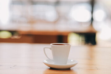 Closeup of coffee cup on table in empty corporate conference room before business meeting in office