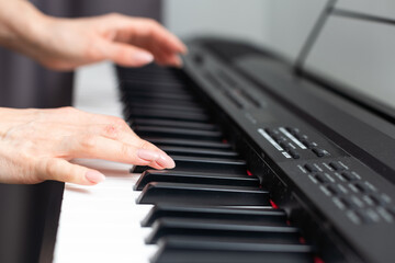 Fototapeta premium keyboard and hands playing the piano